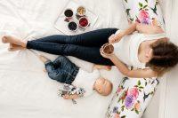 Mother and toddler baby boy, lying in bed, hugging with love, hi